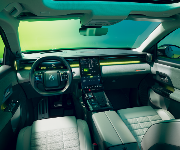 Interior of modern car featuring steering wheel and central touchscreen display.