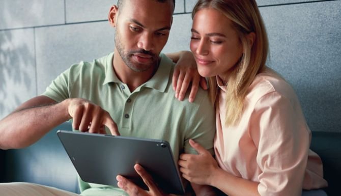Couple looking on a tablet