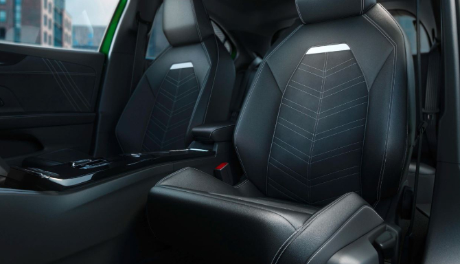 Black leather car seats with white stitching detail.