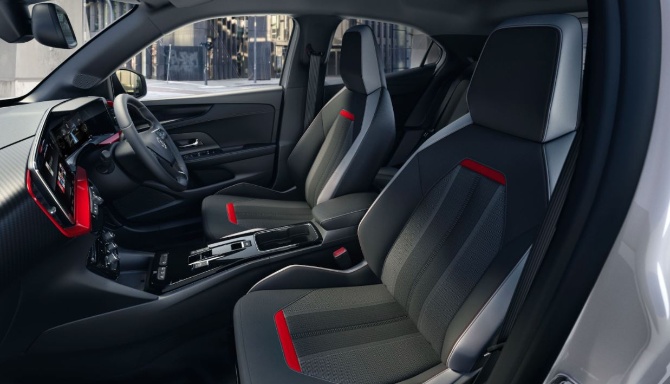 Interior of a Vauxhall Mokka, showing steering wheel, dashboard, and two front seats.