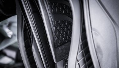 Close-up of black car floor mats with textured pattern.