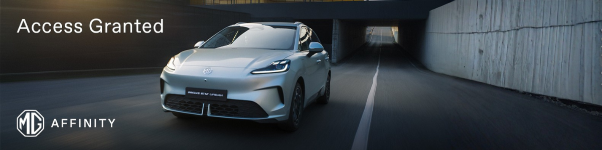 Silver MG EV driving through a tunnel with Access Granted text on the image.