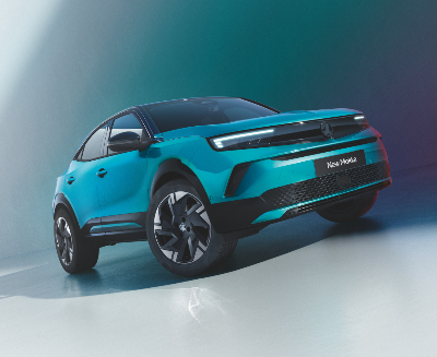 Teal car with sleek design, labelled New Mokka, viewed from the front and side.