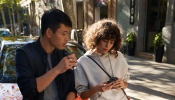 Two people looking on a phone