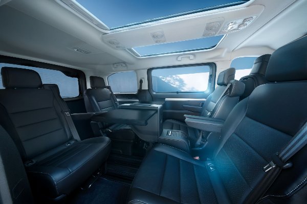 Interior of a car with leather seats and a sunroof.